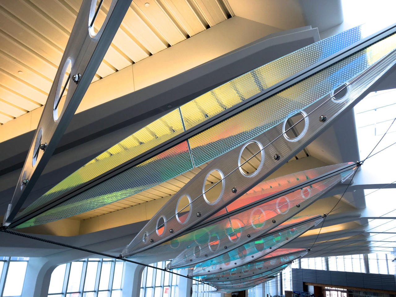 Ed Carpenter’s Wichita Dwight D. Eisenhower National Airport signature sculpture Aloft delights travelers with colorful laminated safety dichroic glass above. | Image 14 | Ed Carpenter, Artist