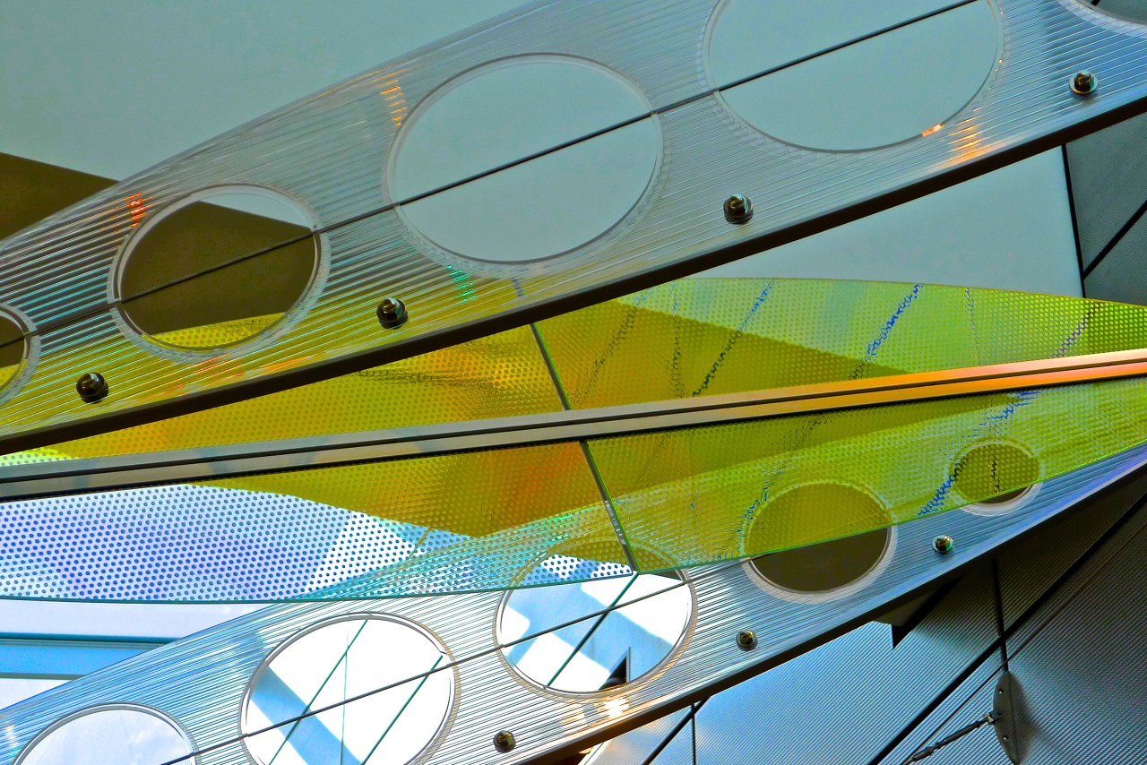 Showing Ed Carpenter’s Wichita Dwight D. Eisenhower National Airport signature sculpture Aloft close up of alternating colorful laminated safety dichroic glass and cellular polycarbonate. | Image 17 | Ed Carpenter, Artist